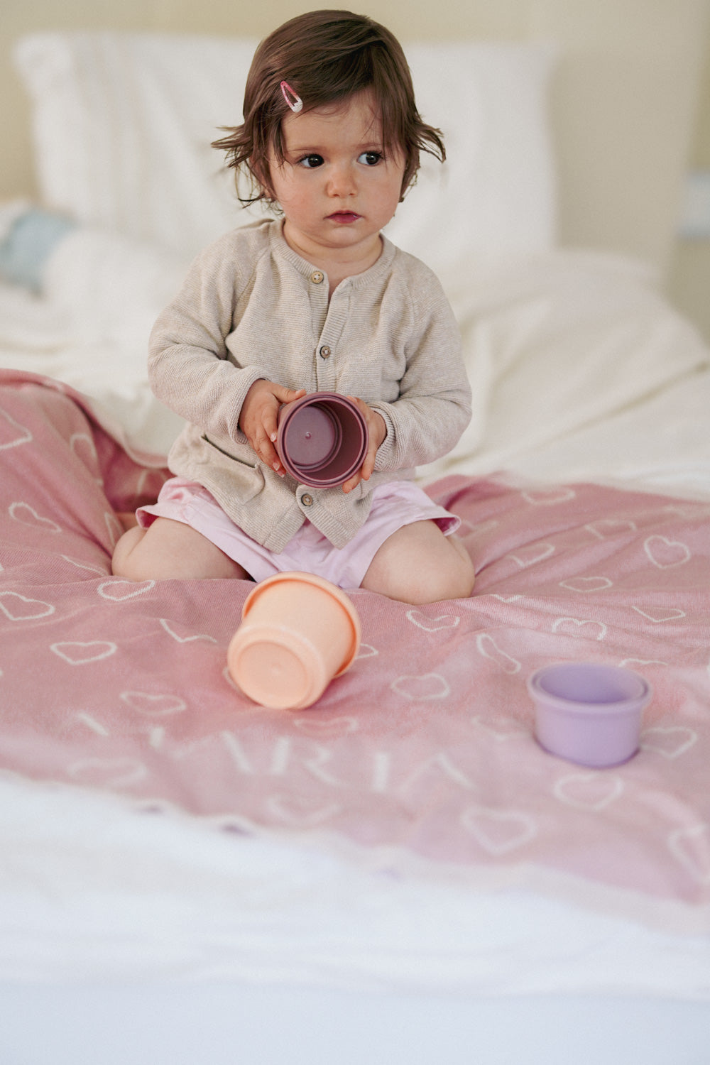 Kleinkind spielt auf personalisierter Babydecke KIND DER STADT in Rosa und Cremeweiß von LILIMOON